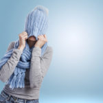 portrait of a pretty young woman covering her head with a wool cap